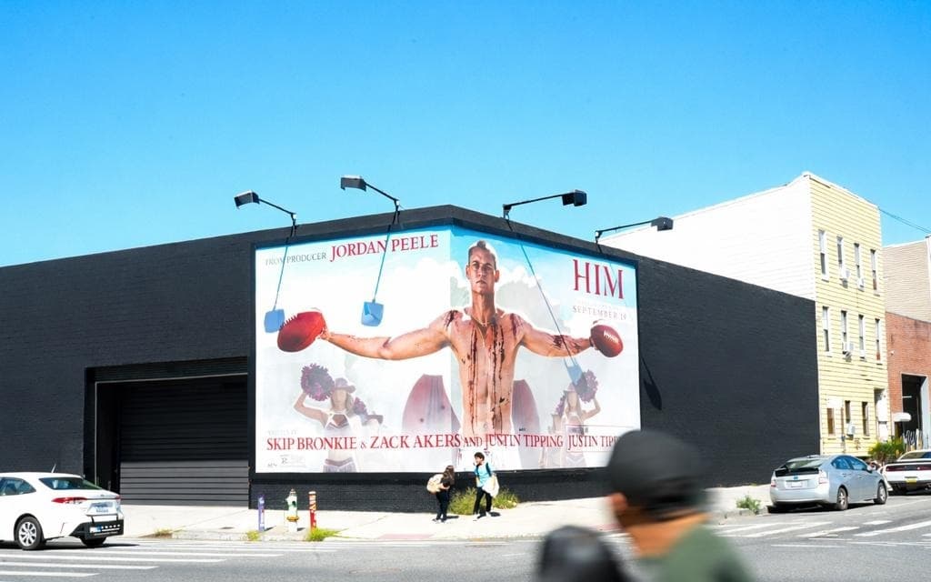 Street-level wallscape advertising on a building facade