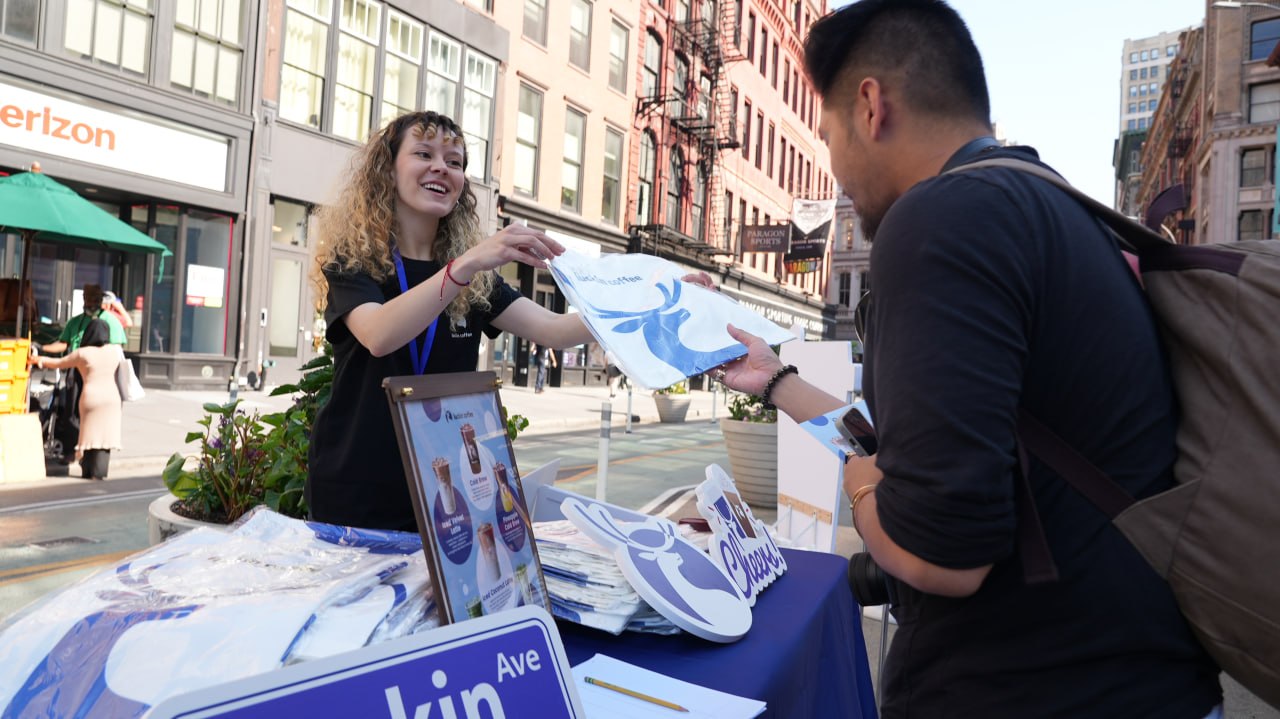 Brand ambassador handing out promotional materials on the street